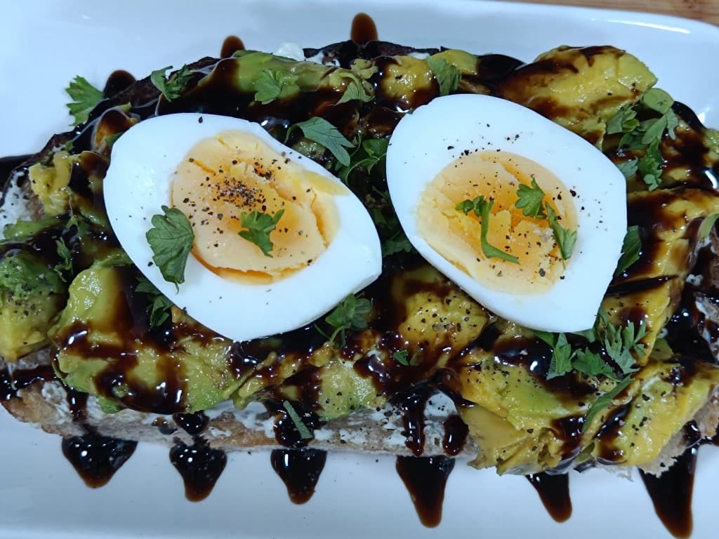 Avocado toast with soft-boiled egg and balsamic glaze