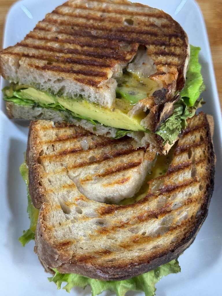 Grilled avocado and lettuce panini