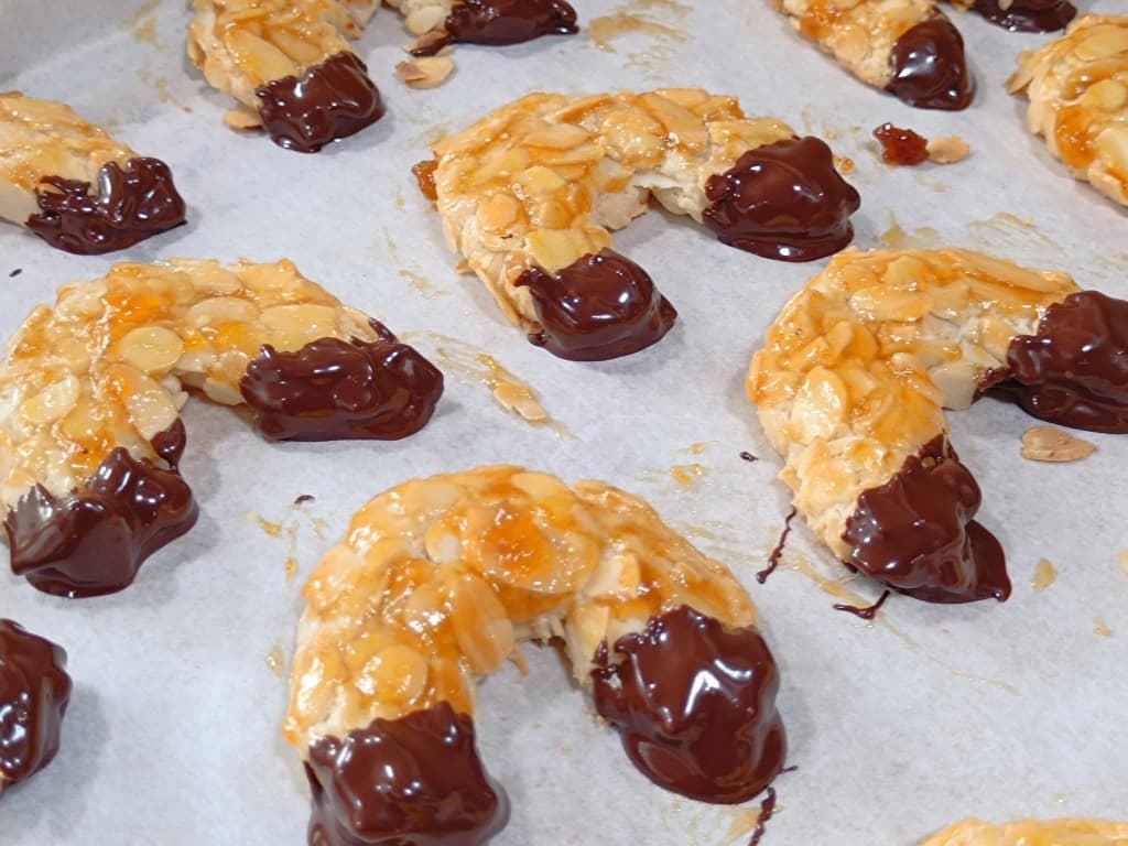 Almond crescent cookies dipped in dark chocolate